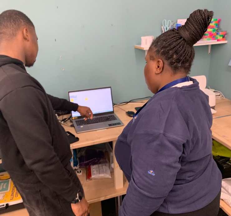 Two learners developing digital skills on a computer together